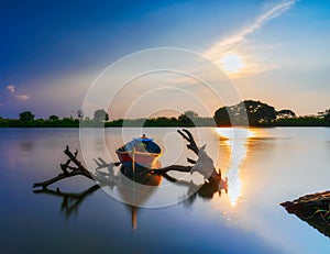 Beautiful sunset in The Lake With Classic Fishing Boat in Indonesia photo