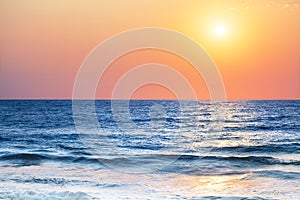 Beautiful sunset landscape, blue sea, ocean waves, tropical island beach, red orange sky, yellow sun glow, morning sunrise, dawn