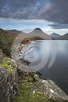 Beautiful sunset landscape image of Wast Water and mountains in