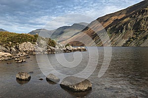 Beautiful sunset landscape image of Wast Water and mountains in