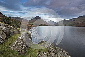 Beautiful sunset landscape image of Wast Water and mountains in