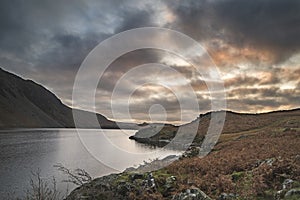 Beautiful sunset landscape image of Wast Water and mountains in