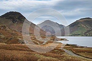 Beautiful sunset landscape image of Wast Water and mountains in photo