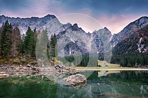 Beautiful sunset landscape of Lago or Laghi di Fusine lake in Italy