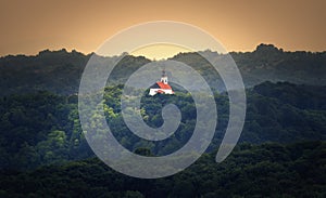 Beautiful sunset landscape scenery of little church on the hill in the forest in Croatia, county hrvatsko zagorje