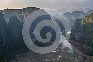 Beautiful sunset landscape viewpoint with white stupa from the top of Mua Cave mountain, Ninh Binh, Tam Coc, Vietnam.