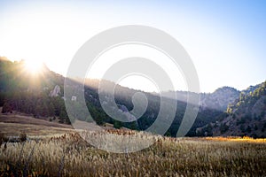 Beautiful sunset light over a field and distant mountains in the front range of Colorado