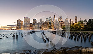 Beautiful Sunset and Lower Manhattan skyline with East River and New York City. Twilight with Reflections