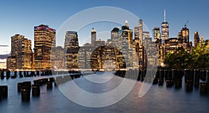 Beautiful Sunset and Lower Manhattan skyline with East River and New York City. Twilight with Reflections