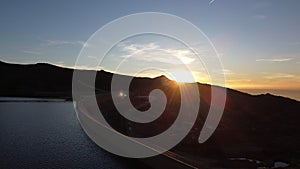 The beautiful sunset in the Maques da Silva Dam with water and rock in the Serra da Estrela Natural Park in Portugal