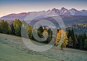 Beautiful sunset on the meadow under the Tatra Mountains at autumn.