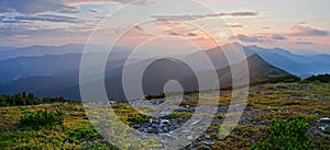 A beautiful sunset in the mountains, panoramic view. Summer mountain landscape. Carpathian mountain ridge Gorgany, Ukraine.