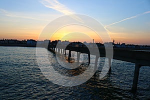 Beautiful sunset next to a long pier