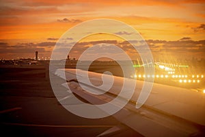 Beautiful sunset over the airport from a plane window on taking off photo