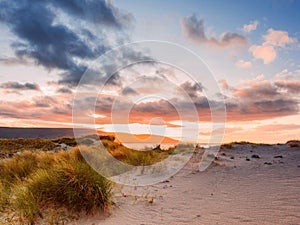 Beautiful sunset over Burren and Atlantic ocean, Cloudy sky, Sand dunes. West coast of Ireland