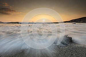 Beautiful sunset over the fizzy ocean on a bright evening in Fistral Beach, Newquay, Cornwall, UK