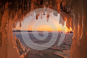 Beautiful sunset over lake Baikal look through an ice cave.