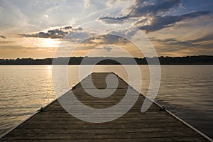 Beautiful sunset over lake landscape with jetty