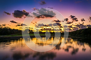 Beautiful sunset over the lake near the golf course in a tropical resort, Punta Cana