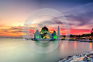 Beautiful sunset over the majestic mosque, Malacca Straits Mosque (Masjid Selat). Soft focus due to slow shutter shot.