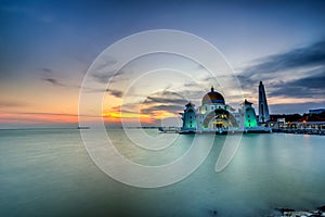 Beautiful sunset over the majestic mosque, Malacca Straits Mosque (Masjid Selat). Soft focus due to slow shutter shot.