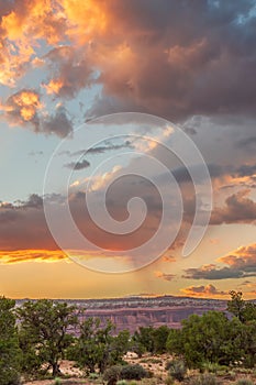 A beautiful sunset over a mountain range with a few clouds in the sky