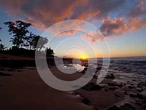 Beautiful Sunset over the ocean and beach with waves moving to shore