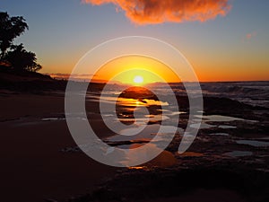 Beautiful Sunset over the ocean with waves moving to shore Sunset Beach