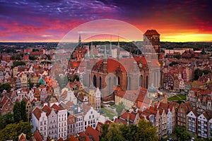 Beautiful sunset over the old town of Gdansk with City Hall and St. Mary Basilica, Poland