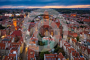 Beautiful sunset over the old town of Gdansk with City Hall and St. Mary Basilica, Poland