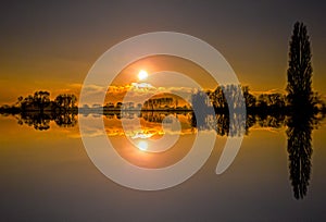 Beautiful sunset over the river with reflection in the water