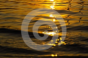 Beautiful sunset over the river. The solar path on the surface of the water. Reflection of the setting sun