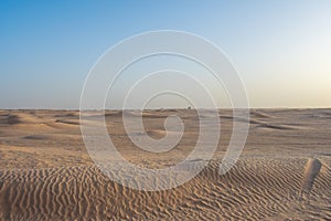 Beautiful sunset over Sahara desert in Douz, Tunisia. Sand and dunes against sky