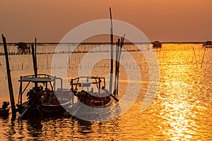 Beautiful sunset over the sea. Dark and golden sunset sky and clouds. Nature background for tranquil and peaceful concept. Sunset