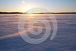 Beautiful sunset over a snowy field.