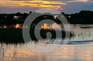 Beautiful sunset over the swamp in Louisiana, the reflection of clouds in the water, USA