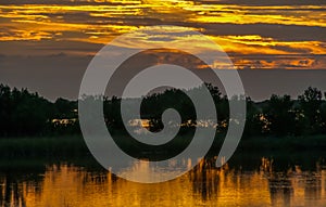 Beautiful sunset over the swamp in Louisiana, the reflection of clouds in the water, USA