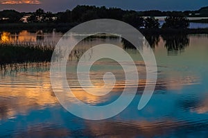 Beautiful sunset over the swamp in Louisiana, the reflection of clouds in the water, USA