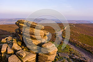 Beautiful sunset over the Wheel Stones found near Derwent Edge in the Peak District National Park, Derbyshire, UK