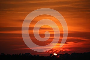 Beautiful sunset with red clouds on a calm evening.