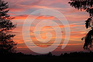 Beautiful sunset with red clouds on a calm evening.