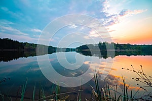 Beautiful sunset is reflected in a large lake. Beautiful soothing landscape