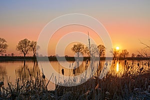 Beautiful sunset on the river in early spring