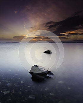 Beautiful Sunset with rocks in the foreground and dramatic clouds in the background