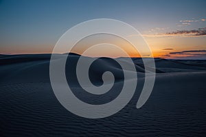 Beautiful sunset in sand dunes over barkhan desert in Kazakhstan