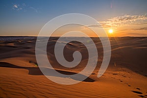 Beautiful sunset in sand dunes over barkhan desert in Kazakhstan