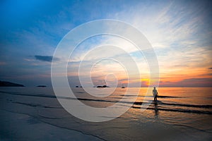 Beautiful sunset on the sea beach, swimming girls silhouette