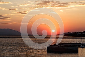 Beautiful sunset with sea and pier in Loutraki, Grecee photo