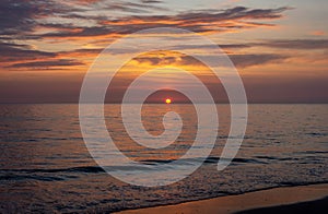 Beautiful sunset at the sea with romantic, colorful sky photographed from the dutch beach at Schoorl