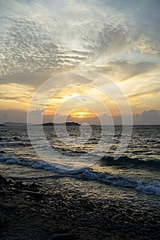 Beautiful sunset seaview on rock beach with beautiful shades of soft wide orange and blue color sky and abstract cloud background